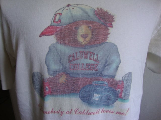 Vintage 9039s Caldwell College Somebody At Caldwell Loves Me White T Shirt Size L Graphic Tee – Easygoing Wear · Trending Graphic Apparel