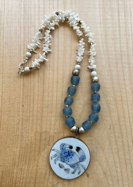 Porcelain Blue Crab Pendant Necklace with recycled Ghana Glass Bone Beads and Silver Accents Graphic Tee – Fan Favorite · Must-Have Style