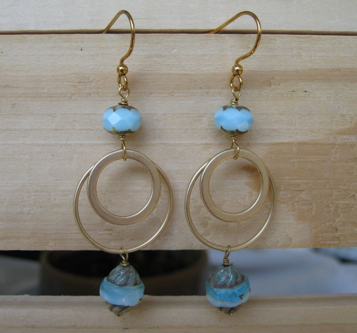 Light BlueWhite Czech Crystals Matte Gold Circular Frames Earrings Graphic Tee – Warm & Stylish · Perfect For Daily Wear