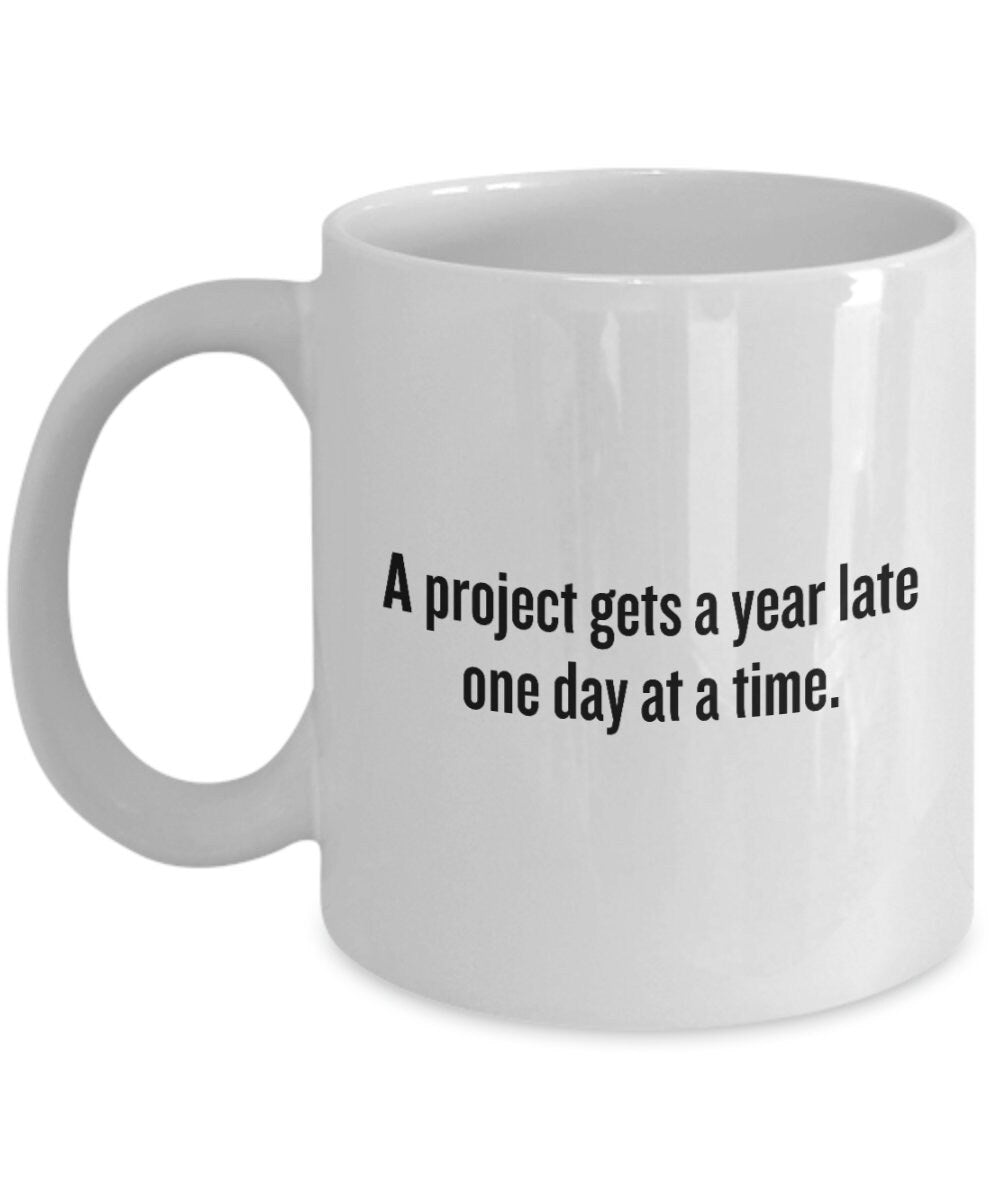 Project Manager Mug Project Management Gift Funny Present For a Project Manager A Project Gets a Year Late One Day At a Time Graphic Tee – Easygoing Wear · High-Quality Print