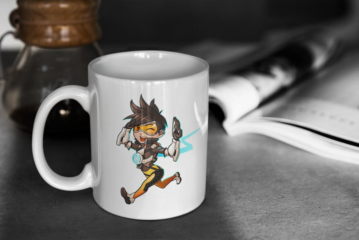 Overwatch 2 Cute Chibi Tracer 11oz White Glossy Mug Perfect Gift for Gamers and Overwatch Fans Graphic Tee – Fan Favorite · High-Quality Print