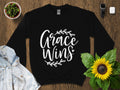 Inspirational Grace Wins Quote T Shirt Elegant Calligraphy with Wreath Positive Message Tee Casual Style Unisex Clothing Graphic Tee – Bold Style · High-Quality Print