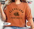 Cleveland Football Shirt Brown Football Gameday Shirt Cleveland Football Apparel Cleveland Sports Apparel Retro Brown Football Fan Gift Graphic Tee – Aesthetic Look · Perfect For Daily Wear