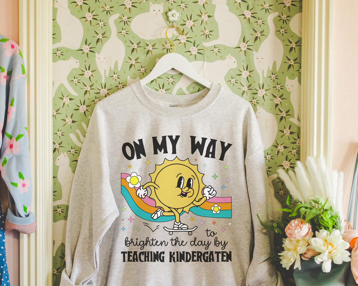 Kindergarten Teacher Sweatshirt with Sun on a Skateboard Funny Kindergarten Crew Shirt New Teaching Job Gift Elementary Education Major Sweatshirt – Bold Style · Perfect For Daily Wear